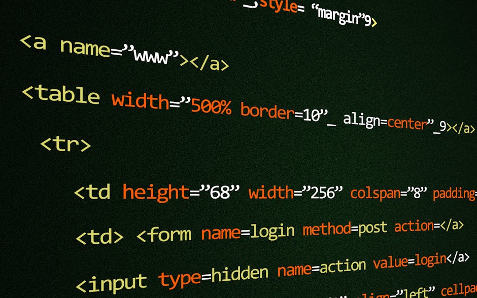 A photograph shows a close-up view of a computer screen displaying lines of HTML code embedded on a dark background. The code features various HTML elements such as tables, table rows, and table data